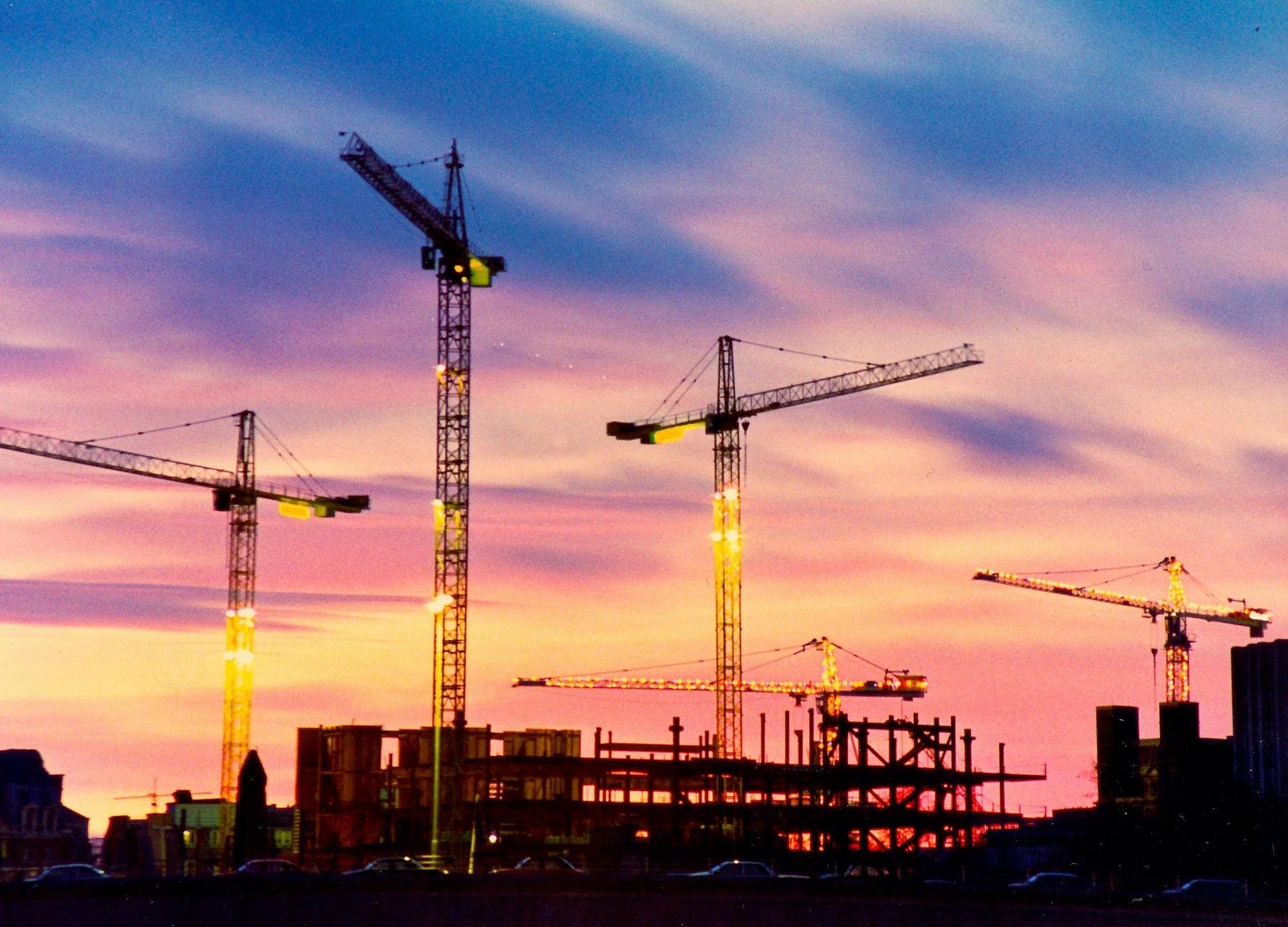 Bygg under oppføring med kraner i solnedgang – bygg og anlegg